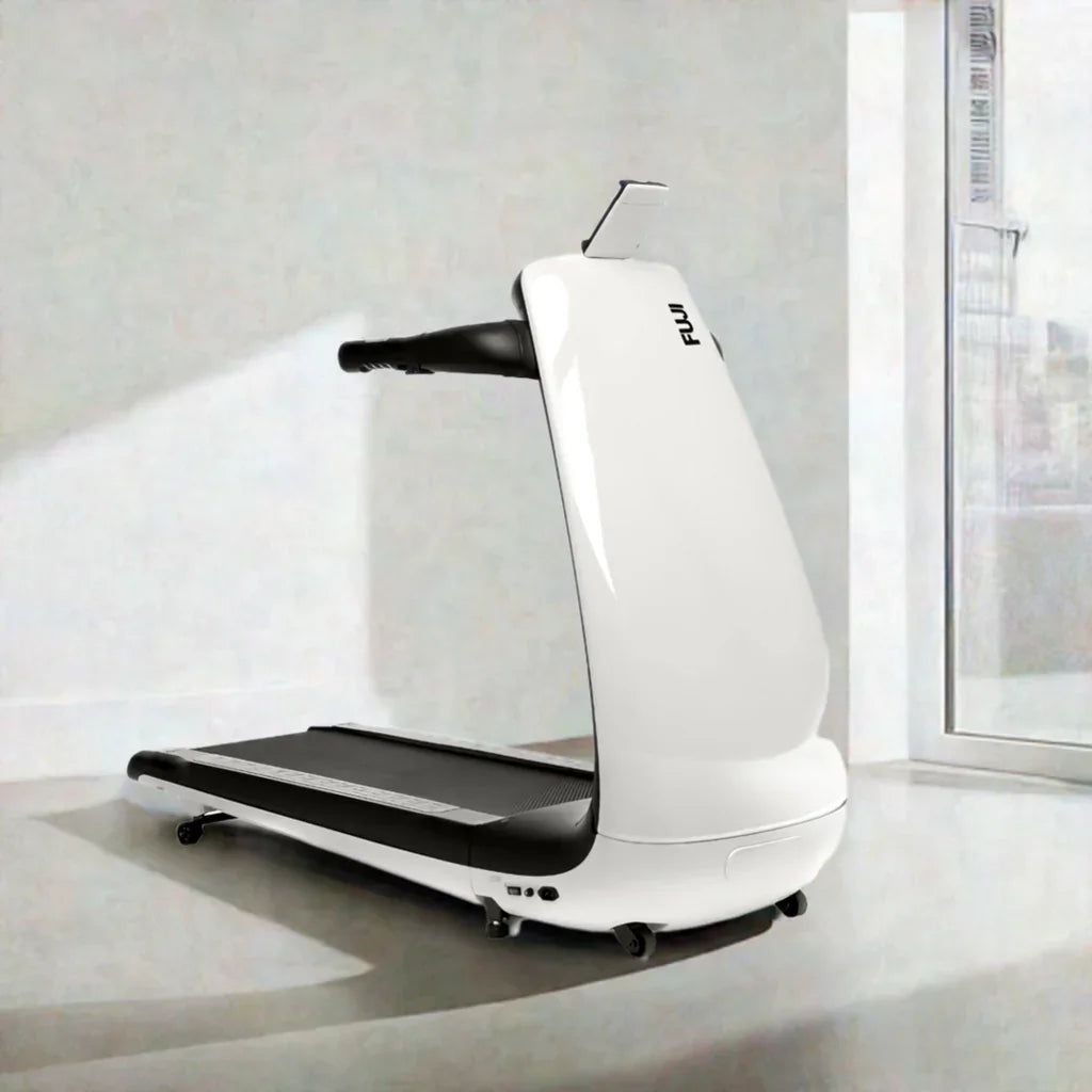 Modern Fuji treadmill in a bright, minimal indoor setting near a large window.