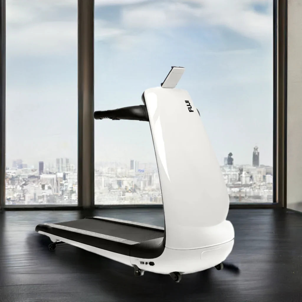 Modern white Fuji treadmill in front of large windows with city skyline view