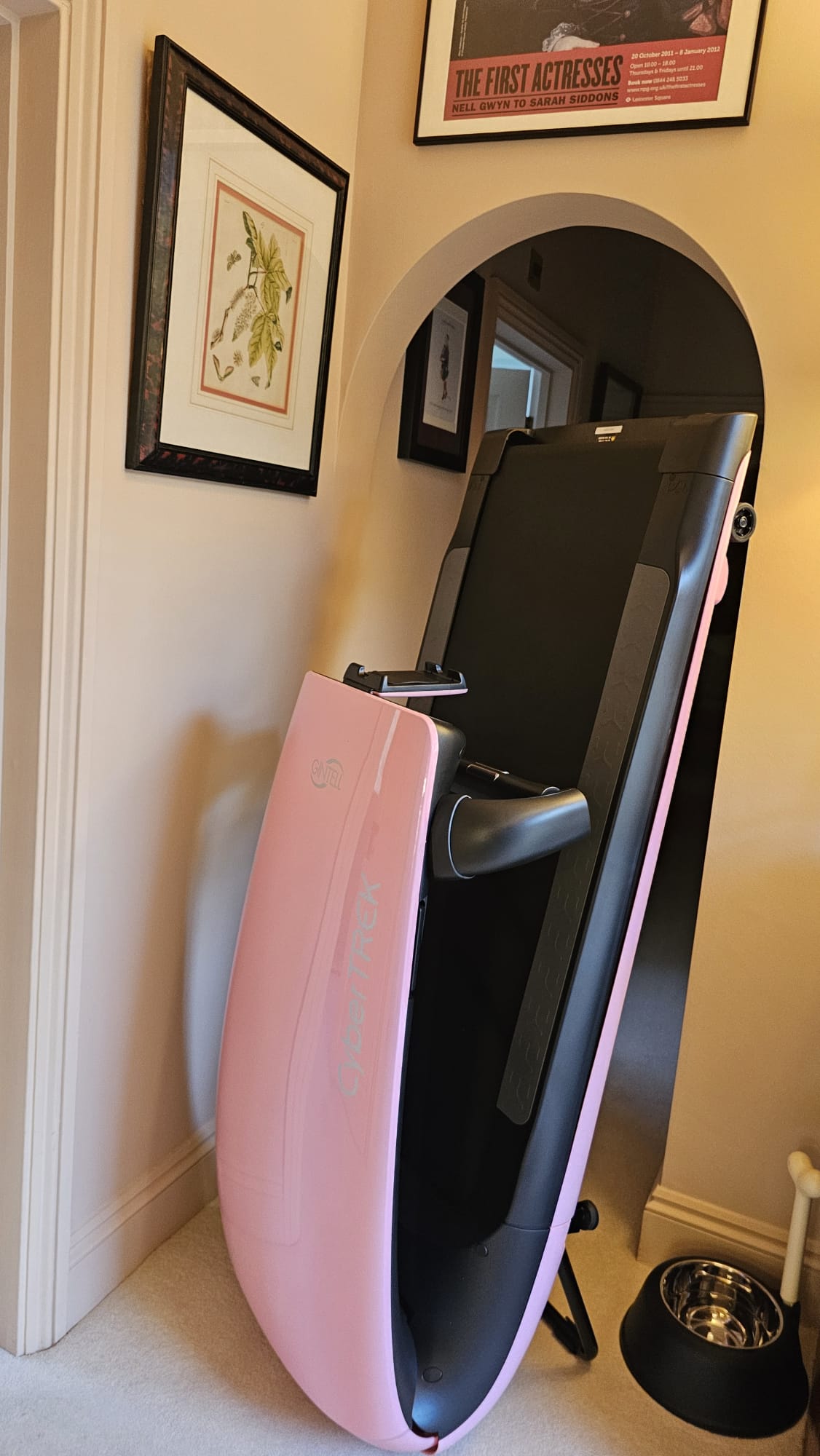 Folded BeHealthy Pink Treadmill neatly stored, showcasing its compact and space-saving design.