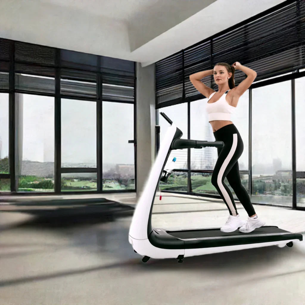 Woman exercising on modern treadmill in bright gym with large windows